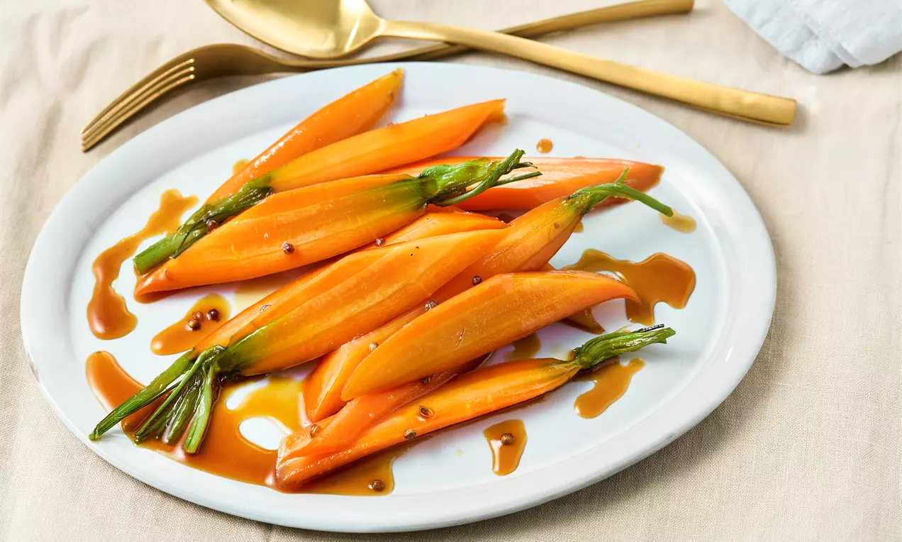 Zarte glasierte Möhren mit Ahornsirup und Gewürzen – einfache Beilage mit süß-würziger Glasur, ideal für festliche Menüs, schnelle Alltagsküche oder als aromatische Gemüsevariation.
