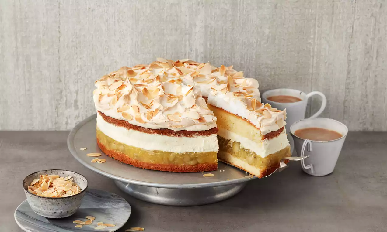 Stachelbeerkuchen mit Baiser: goldener Boden, grüne und rote Beeren und luftige weiße Baiserhaube mit gebräunten Spitzen