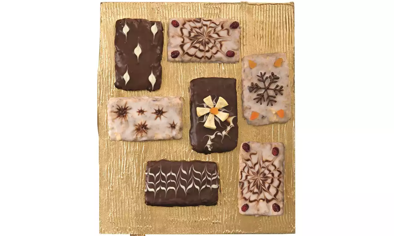 Vánoční polštářky obdélníkového tvaru s různotexturní polevou a dekoracemi na zlatém podkladu tvořící elegantní uspořádání